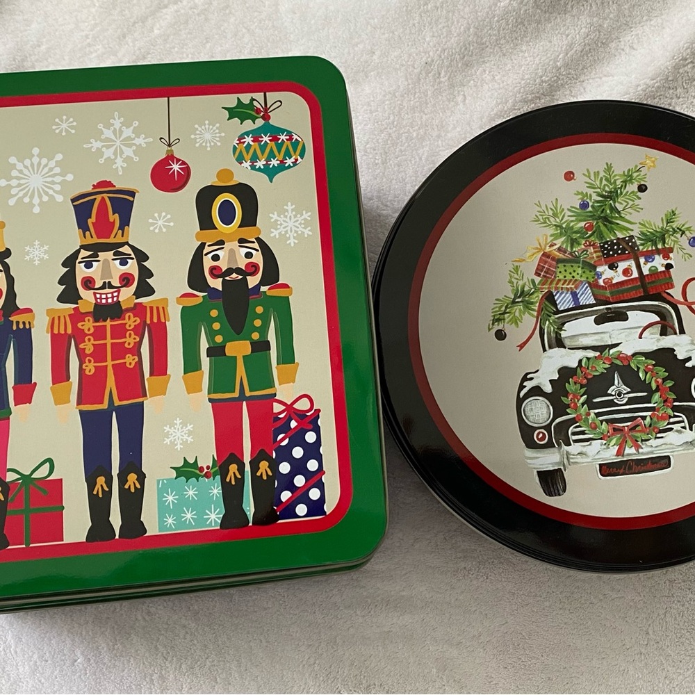 3 holiday cookie tins. 2 square nutcracker tins, 1 with truck carrying tree.